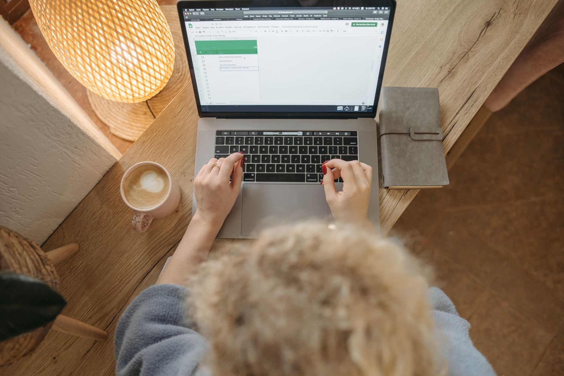 Overhead view of a freelancer working on a laptop with coffee and a journal — the kind of focused work session Flowkitt makes possible